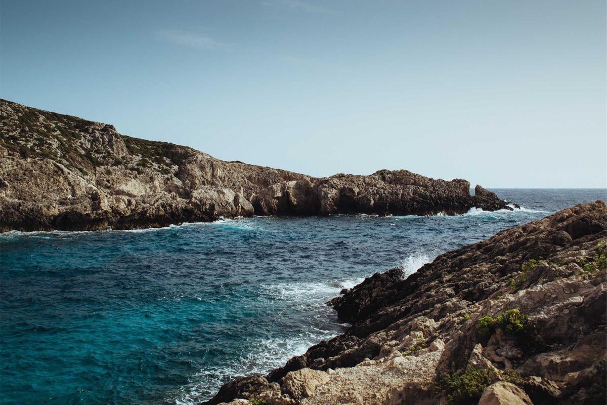 Rocky coastline with clear blue water.